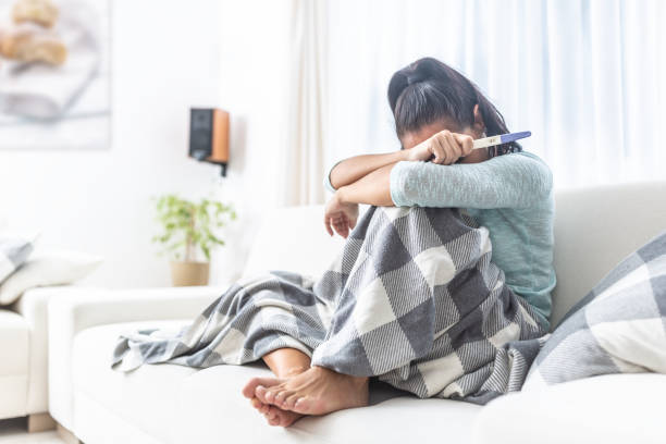 istock Woman crying into a blanket after finding out her preganancy test results. 1284379930