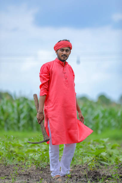 istock Young indian farmer hard working with farm equipment in his field 1284380603