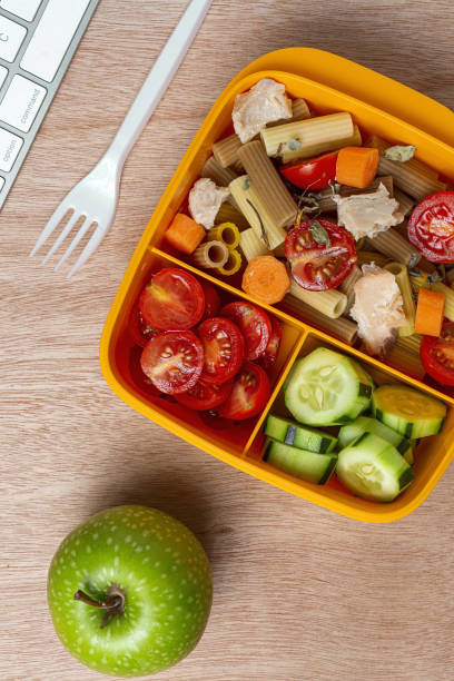 istock Lunch at workplace healthy pasta with tuna, tomatoes, in lunch box 1284380614