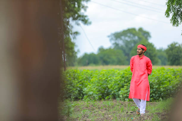 istock young indian farmer walking and observation in his field 1284381105