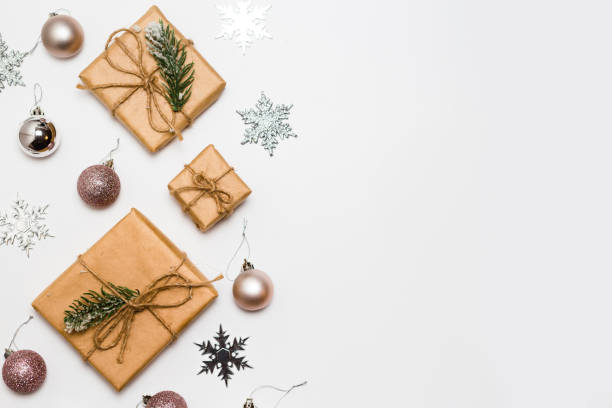 istock Christmas greeting card. Gift boxes and Christmas decorations layout on an isolated white background, top view. Flat lay 1284382207