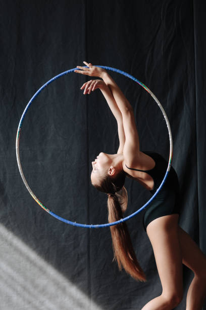 istock Young gymnast girl stretching and training 1284384021