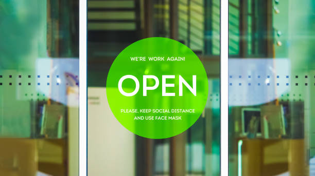 istock Open store, sign on the front door after quarantine. Welcome back! We are work again. Please, keep social distance and use face mask 1284384605