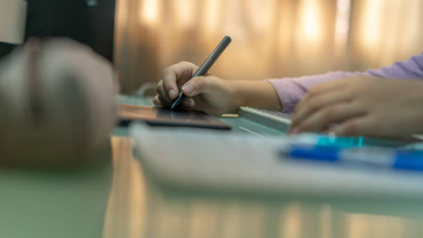istock Close up of Human Hands Using Touchpad Stylus Pen 1284384647