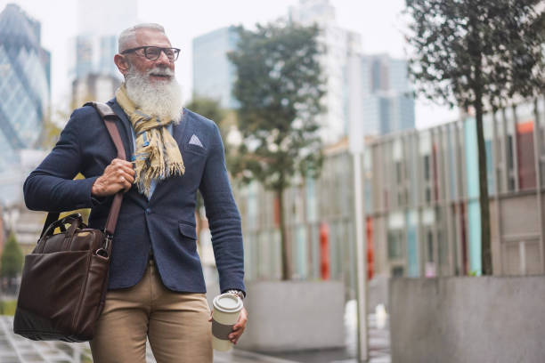 istock Happy hipster senior business man walking to work - Focus on face 1284385646