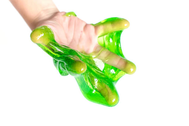 istock Toy called Slime. Mucus in children hand on a white background. Selective focus. 1284385930