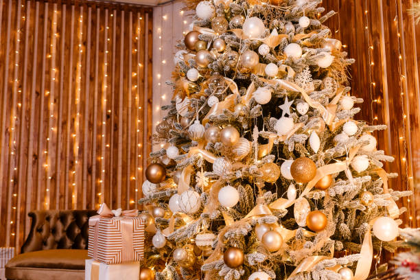 istock Beautiful Christmas interior. studio for photo shoot. a large Christmas tree in gold style. 1284386101