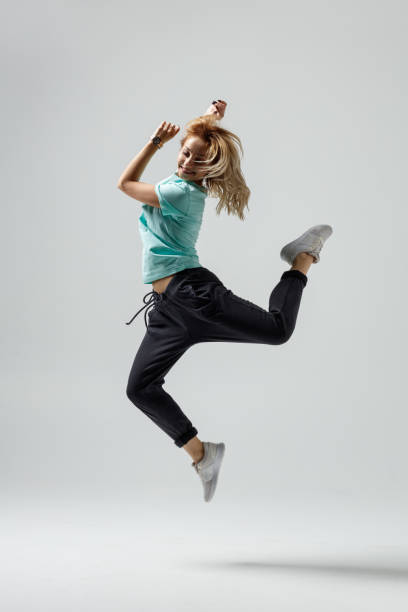 istock Hip hop dancer moving and jumping in photostudio 1284387004