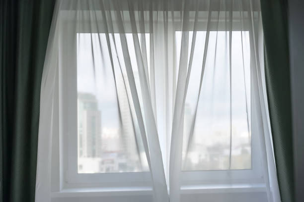 istock fabric transparent white thin curtain on large window blowing by light wind 1284387060
