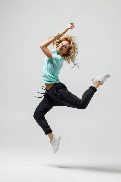 istock Hip hop dancer moving and jumping in studio 1284387272