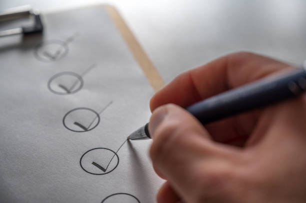 istock checking off a checklist with ballpoint pen on a gray desk 1284388379