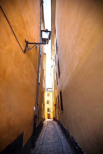 istock European narrow street with latern on wall 1284388601
