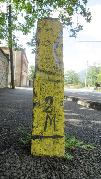 istock Yellow stone sign indicates that under the ground there are electric cables 1284388775
