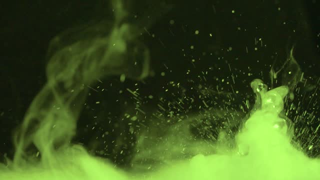 Relaxing videos with splashes and drops of water with fog or smoke on a black background with the ability to loop. Water splash in close-up.Swirl drip and jump water in motion.Chemical reaction water