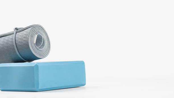 istock Rolled yoga mat and yoga block or brick 1284391382
