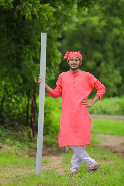 istock Young Indian farmer holding pipe in hand 1284392699