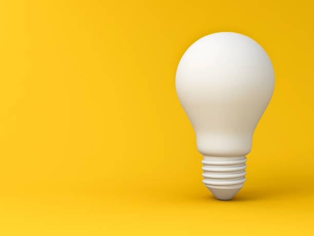 istock Minimal idea light bulb concept isolated on yellow background with shadow 1284392799