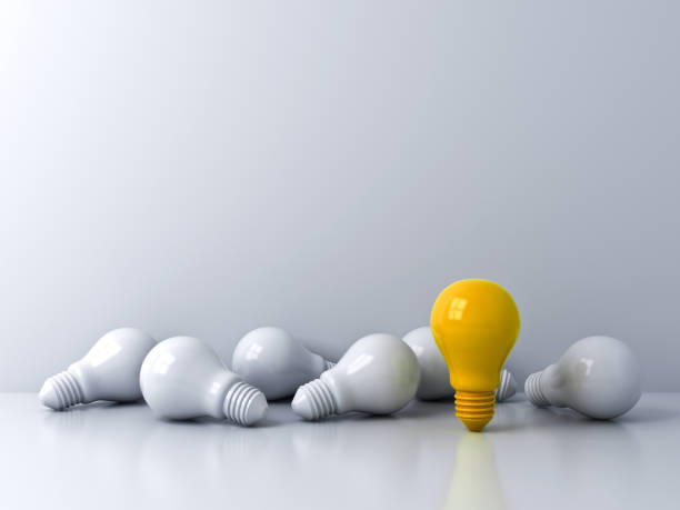 istock One standing yellow idea bulb with white bulbs on white background Stand out from the crowd business creative idea concepts 1284392812