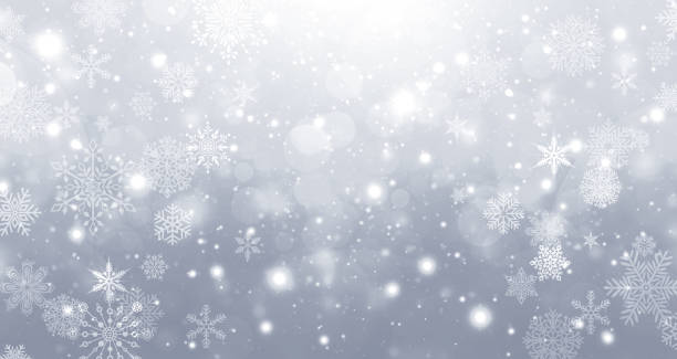 istock Winter silver and white gradient bokeh background with circles and snowflakes 1284393876