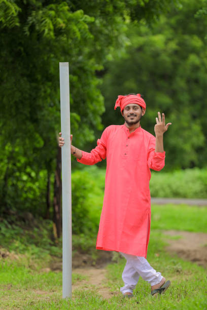 istock Young Indian farmer holding pipe in hand 1284395785