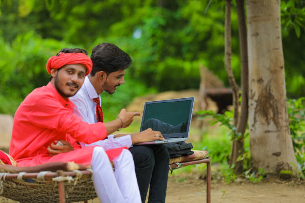 young indian farmer and agronomist or banker discuss at home - child office chaos computer monitor imagens e fotografias de stock