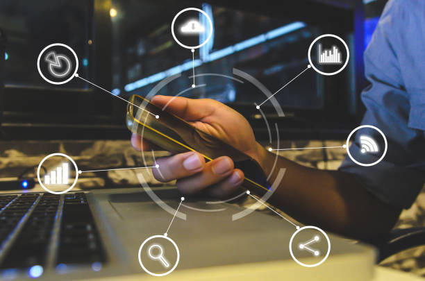 istock Hand holding smartphone with icons 1284398541