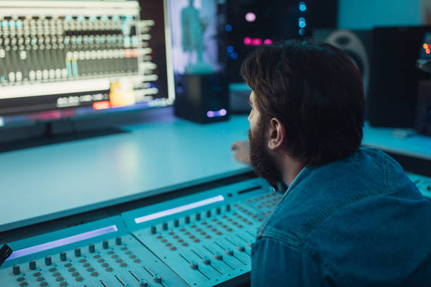 istock Male sound engineer working on mixing panel in recording studio 1284399125