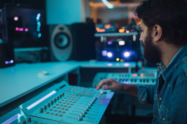 istock Male sound engineer working on mixing panel in recording studio 1284399142