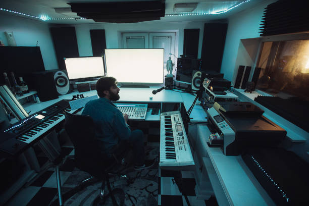 Male sound engineer working on mixing panel in recording studio