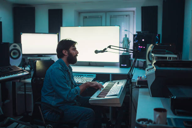 istock Male sound engineer playing synthesizer in recording studio 1284399916