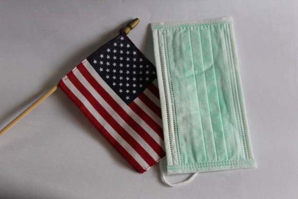 istock American flag and face mask on desk 1284400993