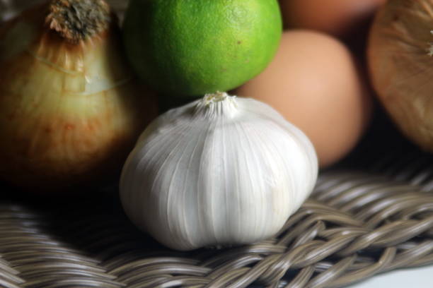 istock Eggs, onions, lemons, garlic, pepper jar, in a wicker basket 1284403933