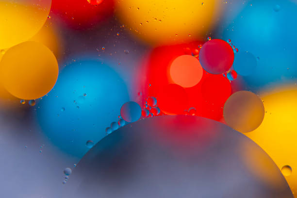 istock colored drops of oil liquid on glass. abstraction background texture 1284405337