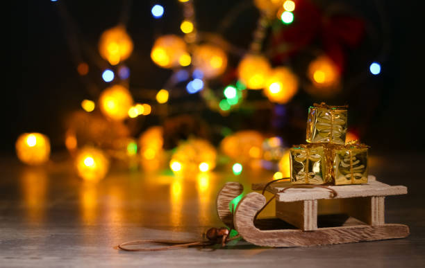 istock Wooden decorative sledge with presents bokeh 1284405556
