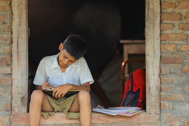istock Cute indian child studying at home 1284407063
