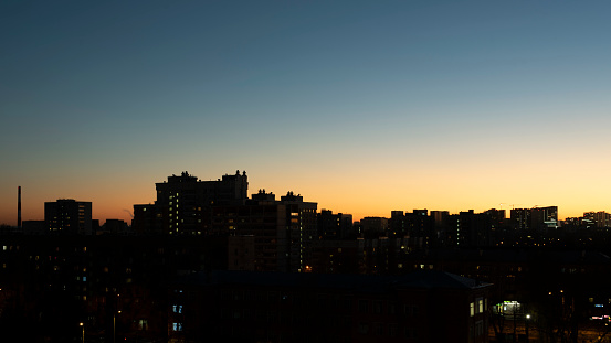 Silhouettes of buildings in the sun flare. Cityscape.