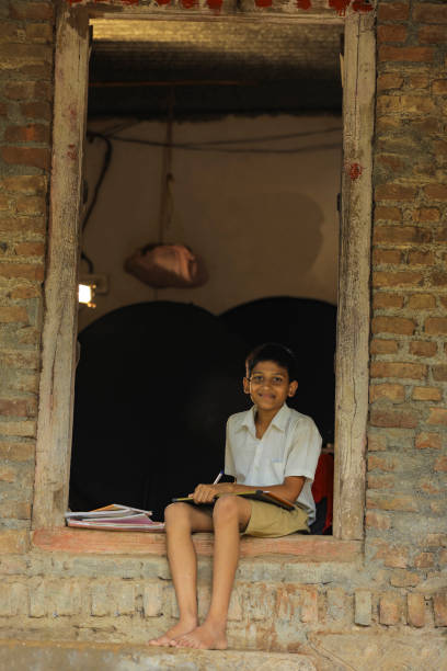 istock Cute indian child studying at home 1284408141
