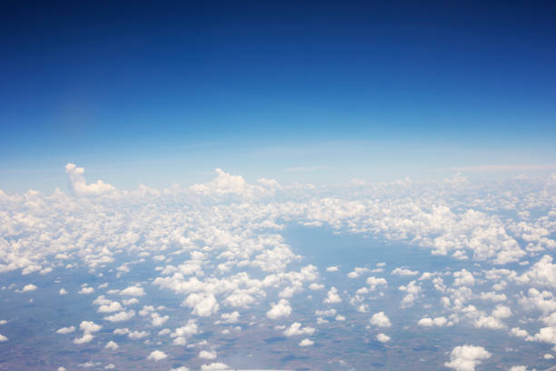 istock Blue sky background and white clouds soft focus, top view take a picture on airplane. 1284408439