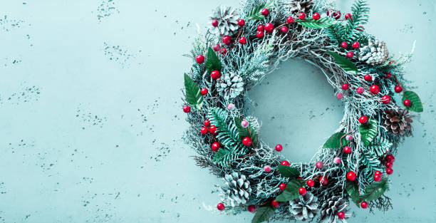 istock Christmas wreath on pastel blue background - winter home decoration 1284409259