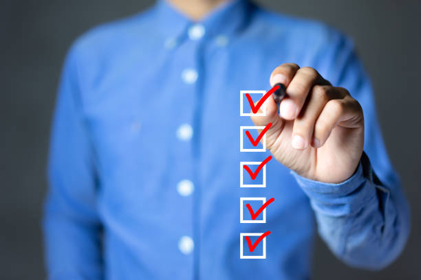 istock Businessman checking mark on the checkbox with marker red, Checklist concept 1284409618