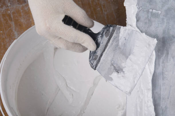 istock on a large spatula apply a mixture for sealing cracks 1284410946