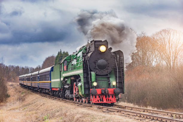 istock Steam train moves at autumn sunset time. 1284411255