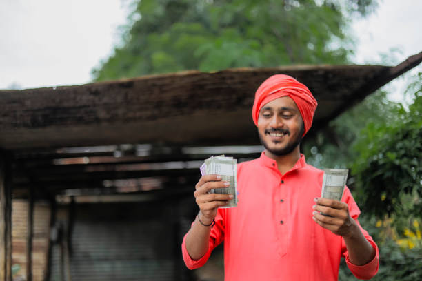 istock Young indian farmer counting money 1284411353