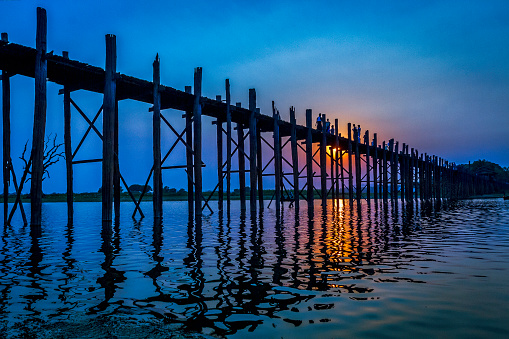 U Bein Bridge crossing Taungthaman Lake near Amarapura in Myanmar. The was built around 1850 and is believed to be the oldest and (once) longest teakwood bridge in the world