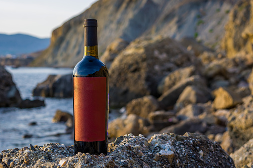 Bottle of wine at sea during sunset
