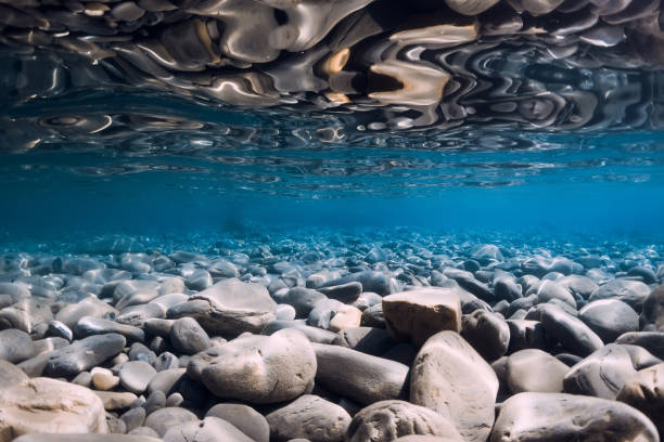 istock Underwater sea with stones, reflection and blue water. 1284413001