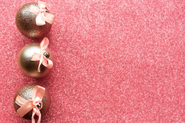 istock Christmas baubles with bows on glitter background, copy space for the text 1284413799