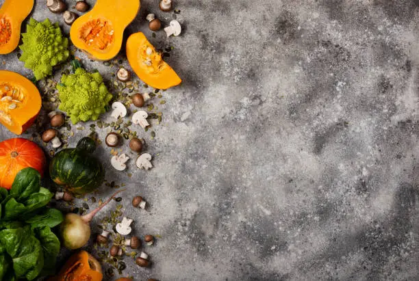 Photo of pumpkin and fresh vegetables and herbs. Top view with copy space.