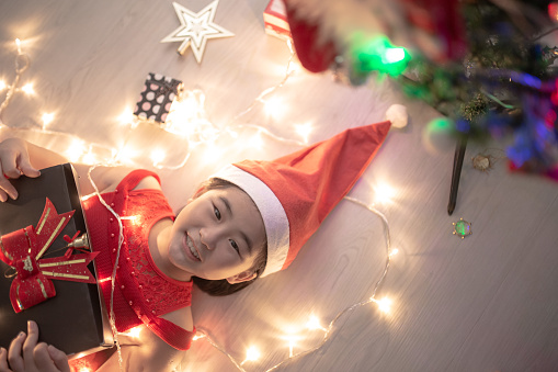 Asian Chinese girl happily receive present with smiling face on camera.