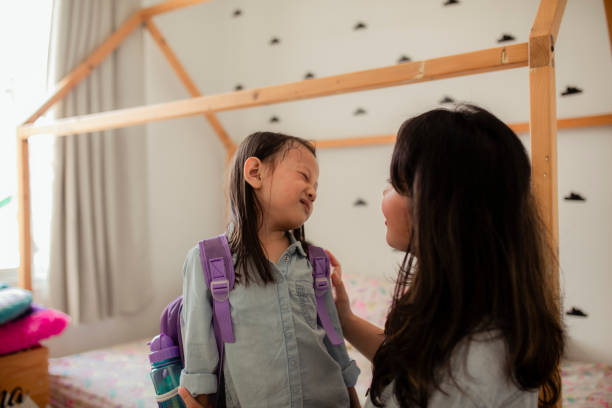 istock Asian mother helping daughter get ready for school 1284415017